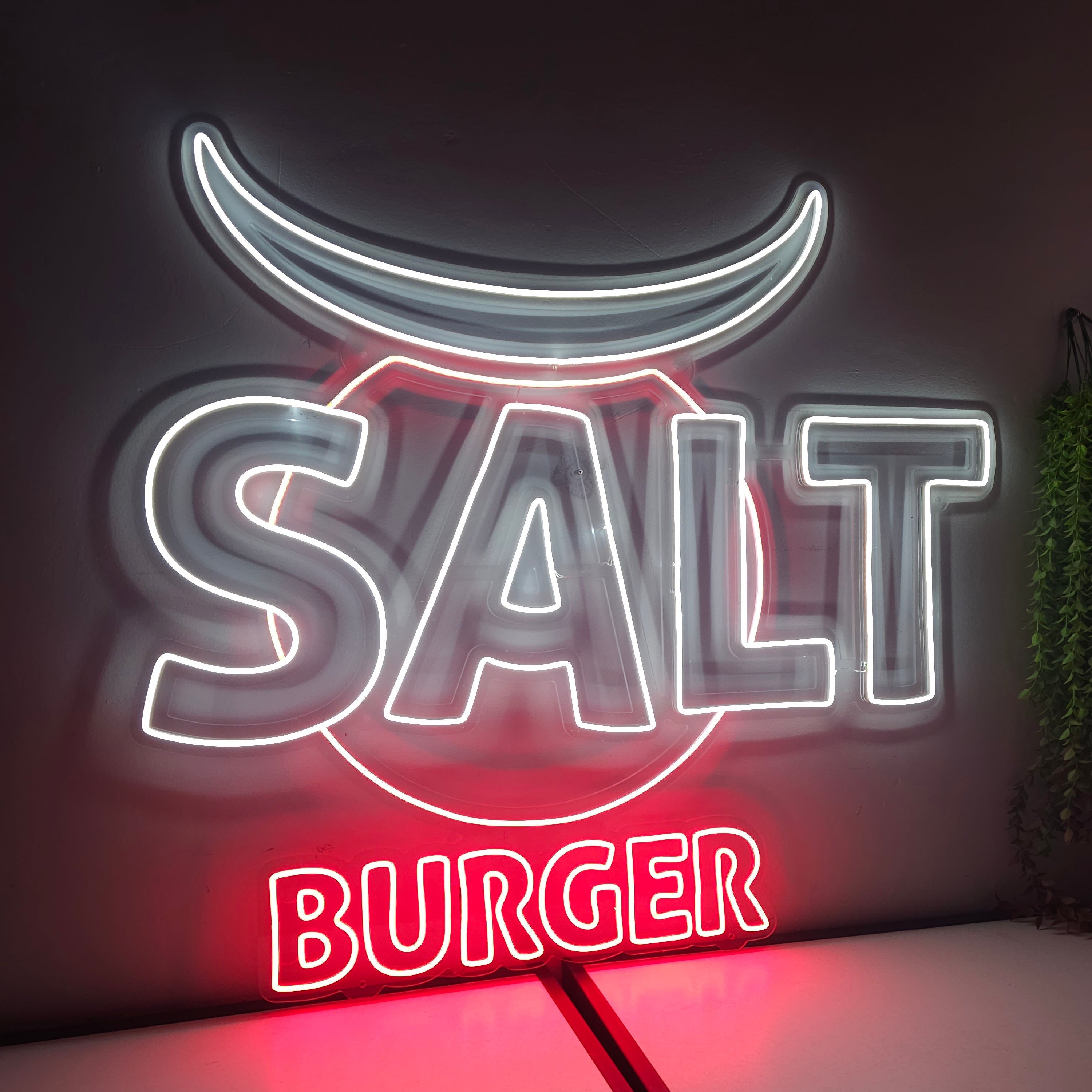 Neon sign for 'Salt Burger' on a dark background